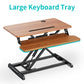 standing desk converter with a large keyboard tray brown